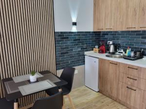 a small kitchen with a table and a sink at Martinas Lake Front Apartment in Ohrid