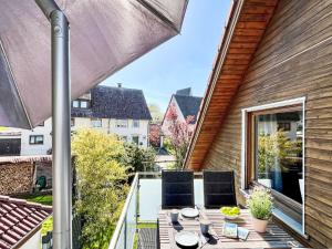 a patio with a table and chairs on a balcony at Apartment Land in Sicht by Interhome in Rulfingen