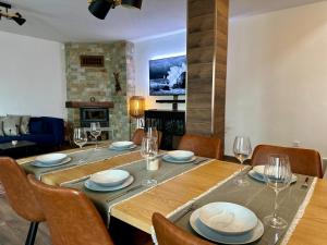a dining room with a table and chairs and a fireplace at Alpine View Villa in Razlog