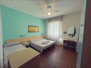 a hotel room with two beds and a table at Hotel Pic Nic in Gatteo a Mare +13 photos