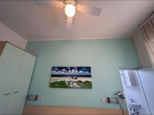 a room with a ceiling fan and a painting on the wall at Hotel Pic Nic in Gatteo a Mare
