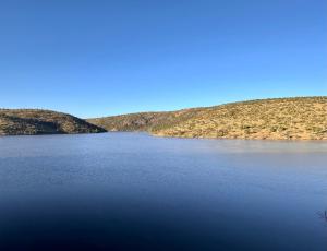 a view of a lake with hills in the background at Fish Eagle Manor in Warmbaths +36 photos