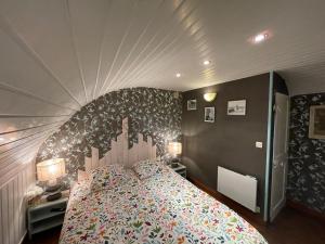 a bedroom with a large bed with a large headboard at Côte & Mer in Fécamp
