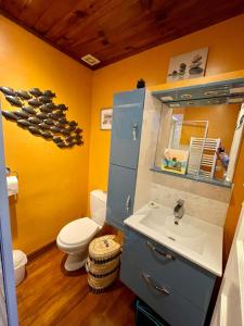 a bathroom with a sink and a toilet and a mirror at Côte & Mer in Fécamp