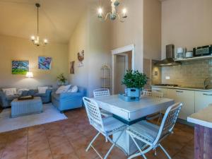 a kitchen and living room with a table and chairs at Holiday Home La Carraia by Interhome in Bibbona