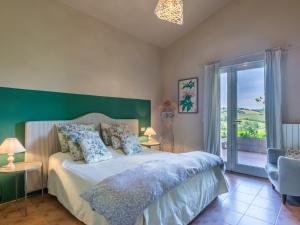 a bedroom with a bed with a green wall at Holiday Home La Carraia by Interhome in Bibbona
