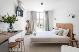 a hotel room with a bed and a desk at Poolside Architect Studios in Novalja