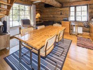 ein Esszimmer mit einem Holztisch und Stühlen in der Unterkunft Holiday Home Örtsylä a by Interhome in Salla