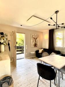 a living room with a table and a couch at Tiny Ferienhaus 4 am Rimbach in Steinau an der Strasse in Steinau an der Straße