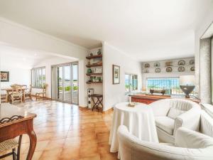 a living room with white furniture and a table at Holiday Home Xoroi by Interhome in Colonia de Sant Pere +20 photos