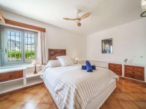 a bedroom with a bed and a ceiling fan at Holiday Home Xoroi by Interhome in Colonia de Sant Pere