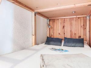 a bed in a room with a wooden wall at Apartment La Comtesse-9 by Interhome in Saint-Gervais-les-Bains