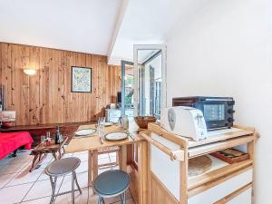 a room with a table with a microwave and chairs at Apartment La Comtesse-9 by Interhome in Saint-Gervais-les-Bains +17 photos