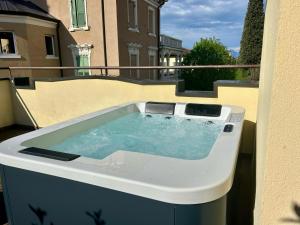 a hot tub on the balcony of a building at The Ziba Hotel & Spa in Peschiera del Garda
