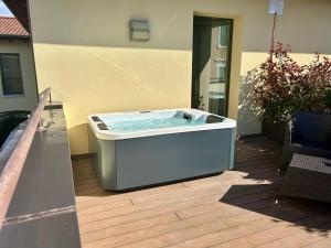 a hot tub sitting on a patio next to a building at The Ziba Hotel & Spa in Peschiera del Garda