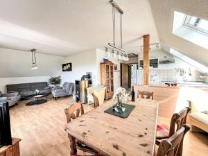 a dining room and living room with a wooden table at Apartment Grandpa by Interhome in Frankenau