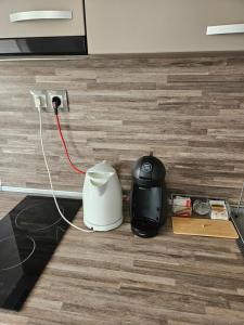 a blender plugged into an outlet on a floor at Апартамент Цветелина in Hisarya