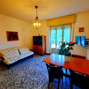 a living room with a couch and a table at Casa Maioli - Your Mountain Holiday in Casargo