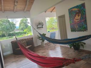 a hammock in a living room with at Trekkers haven Bed & Spanish lessons in Piedecuesta
