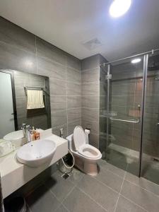 a bathroom with a toilet and a sink and a shower at Happy Home in Ha Long