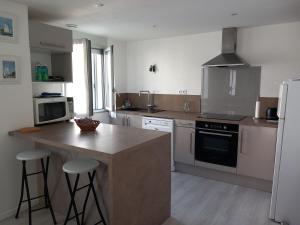 a kitchen with a counter and a stove top oven at Maison à 100m de la plage in La Turballe +9 photos
