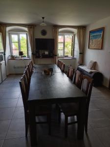 a dining room with a long table and chairs at Chalupa u Jirky in Staré Ransko +12 photos
