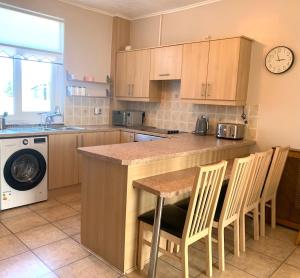 a kitchen with a counter and a table and chairs at 3BR House By Cozy Quarters Property Management Contractors Accommodation Trimdon Grange With Easy access to A1 in Trimdon Grange +8 photos