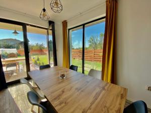 a conference room with a wooden table and chairs at Sea You Guest House in Ezerets