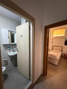 a bathroom with a toilet and a sink and a room at FAMİLY PLAs HOME in Edirne