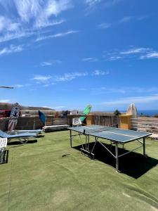 a ping pong table sitting on top of a yard at Adeje - TwinFin Hostel & Surf Yoga Camp in Callao Salvaje