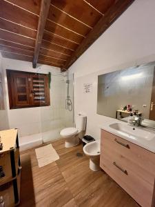 a bathroom with two toilets and a sink at Adeje - TwinFin Hostel & Surf Yoga Camp in Callao Salvaje