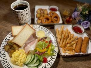 a table with plates of food and french fries at Hotel Relax I in Taipei