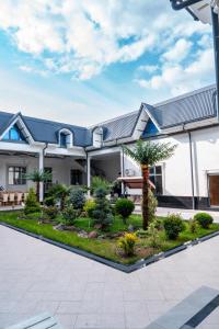 サマルカンドにあるGOLD STAR PALACE hotelの庭のある家の外観