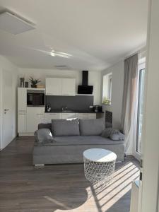 a living room with a couch and a table at Thirty for Three in Kürten