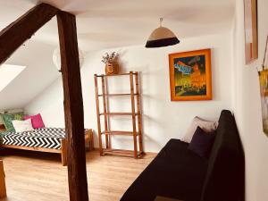 a living room with a ladder and a couch at Dom w Skolitach in Skolity