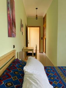 a bedroom with a bed and a table in it at Dyafat Abla in Oulad Akkou