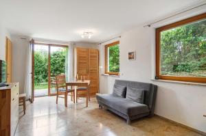 a living room with a couch and a table at Ferienwohnungen Im Rosengarten in Bodman-Ludwigshafen