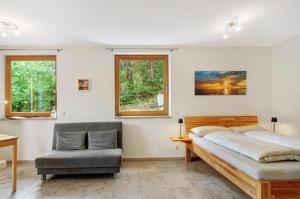 a bedroom with a bed and a chair at Ferienwohnungen Im Rosengarten in Bodman-Ludwigshafen