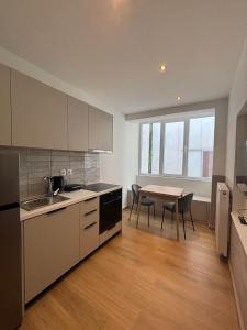 a kitchen with a table and a dining room at City Keys Volos in Volos