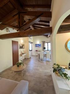 a large living room with wooden ceilings and a table at Casale Antica Cassia Beauty Spa in Rome