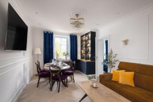a living room with a couch and a table at Westminster Apartments in Kudowa-Zdrój