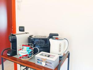 a table with a printer and other appliances on it at Da Faby e Marcy in Settimo San Pietro