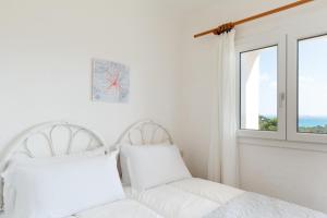 Ένα ή περισσότερα κρεβάτια σε δωμάτιο στο Casa Sottovento a Porto Cervo by Wonderful Italy