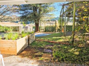 a garden with a fence and a swing set at Anamcara Villa 3, Natal Midlands Balgowan in Balgowan +14 photos
