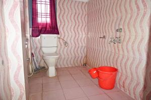 a small bathroom with a toilet and two buckets at FLAT NO 201 Entire 1BHK & 2BHK private apartments with personal kitchen TAJ RESIDENCY Holiday Homestay in Jorhat