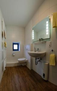 une salle de bain blanche avec un lavabo et des toilettes dans l'établissement Urlaub im historischen Mitteltor, à Xanten