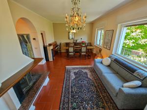a living room with a couch and a dining room at Pianoforte in Gravedona