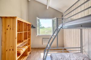 a bedroom with a bunk bed and a window at La Grange de Léo in Salignac Eyvigues +34 photos