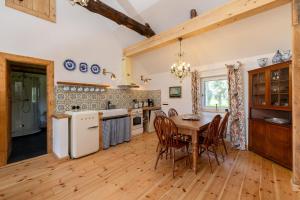 a kitchen and dining room with a table and chairs at Landhaus Möhlend in Waase