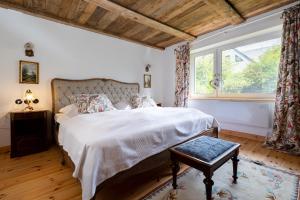 a bedroom with a large bed and a window at Landhaus Möhlend in Waase